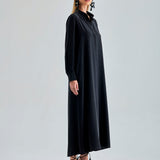 Sleek black silk dress draping beautifully for formal events
