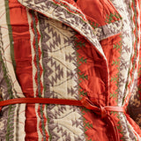 Eye-catching coral jacket featuring dynamic fringed detailing