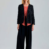 Elegant black jacket featuring subtle floral accents and chic sleeves
