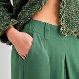 Elegant green high-rise trousers with pleated detailing and wide-leg design