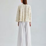 Luxurious ivory jacket with sophisticated floral accents and sleek silhouette