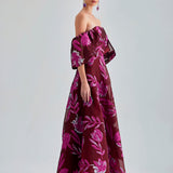 Zelene Gown Red with seductive open back and bold floral patterns, ideal for high-profile events